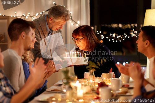 Image of happy family having birthday party at home