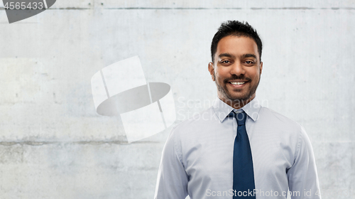 Image of indian businessman in shirt with tie over concrete