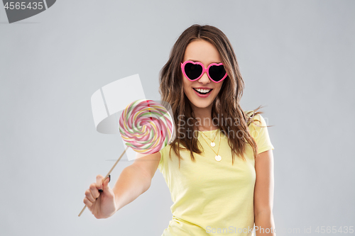Image of teenage girl in sunglasses with lollipop
