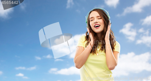 Image of happy young woman or teenage girl with headphones
