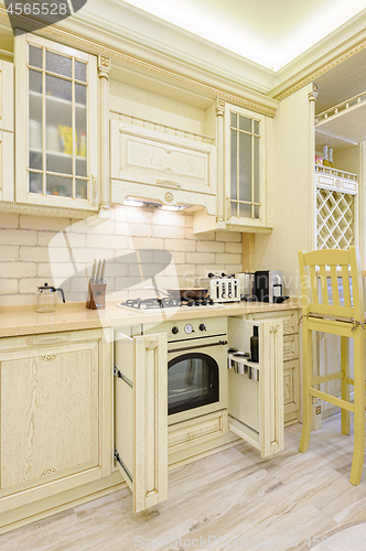 Image of Luxury modern beige kitchen closeup, some drawers open