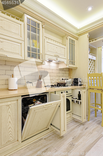 Image of Luxury modern beige kitchen closeup, some drawers open