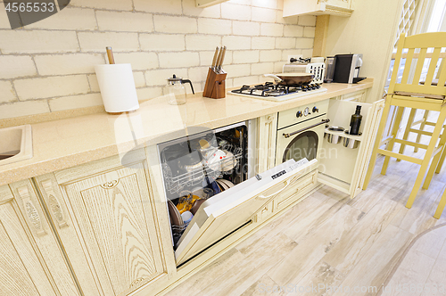 Image of Luxury modern beige kitchen closeup, some drawers open