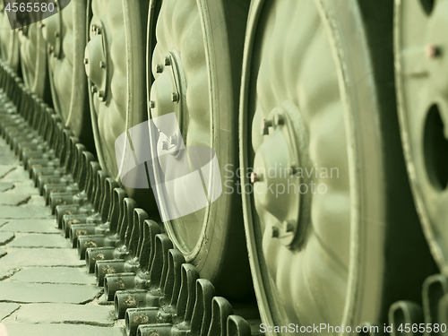 Image of Tracked military equipment close-up, toned in green