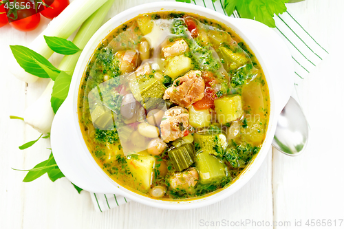 Image of Soup with pisto sauce in bowl on board top