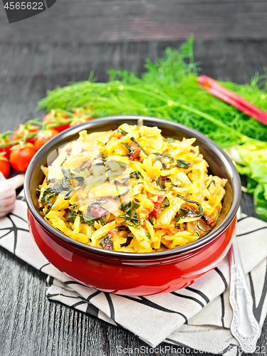 Image of Cabbage stew with chard in bowl on black board