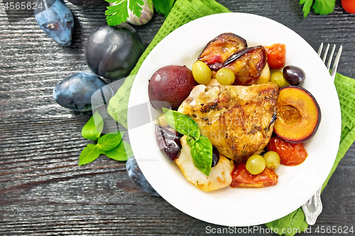 Image of Chicken with fruits and tomatoes in plate on board top
