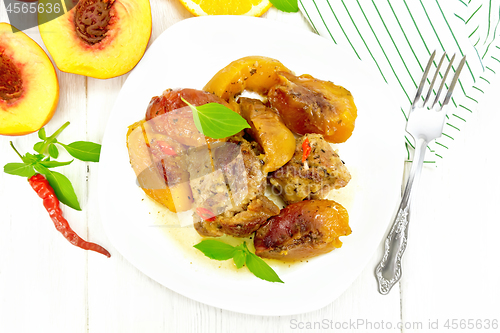 Image of Turkey with peaches in plate on board top