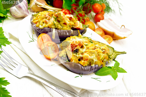 Image of Eggplant stuffed smoked brisket and vegetables in plate on board