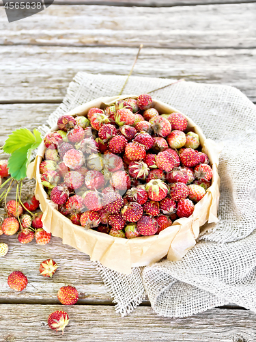 Image of Strawberries in box on wooden old board