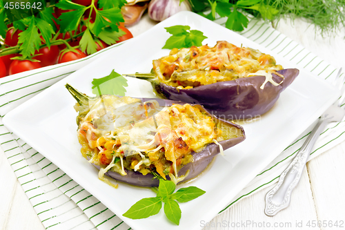Image of Eggplant stuffed brisket and vegetables in plate on board