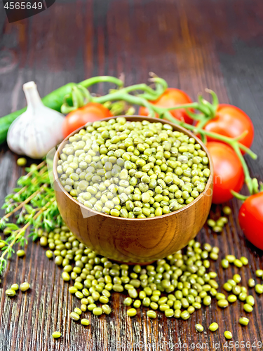 Image of Mung beans  in bowl with vegetables and thyme on board