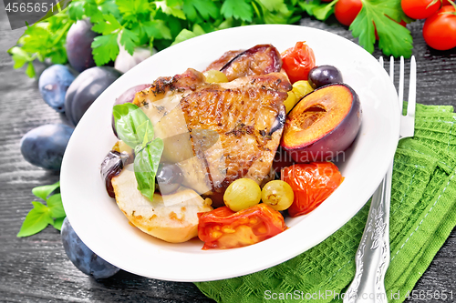 Image of Chicken with fruits and tomatoes in plate on table