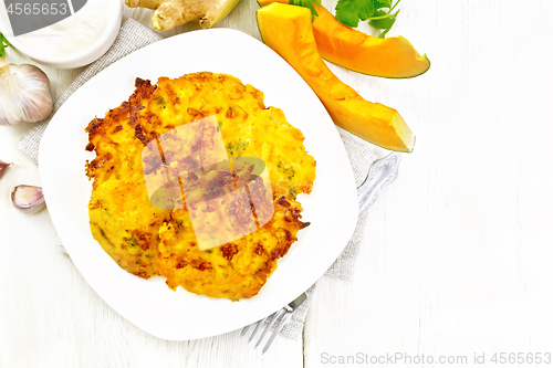 Image of Pancakes of pumpkin in plate on light board top