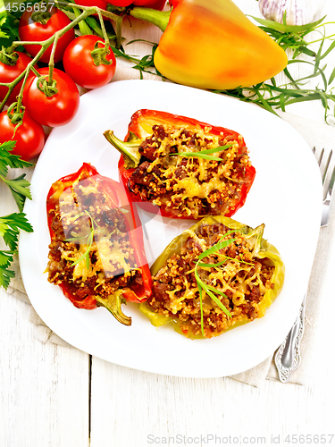 Image of Pepper stuffed with meat and couscous in plate on board top