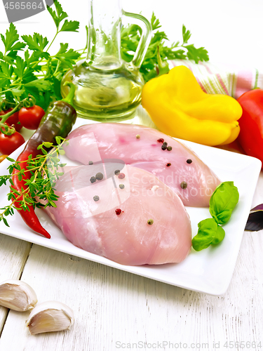 Image of Chicken breast raw in plate on light board