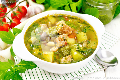 Image of Soup with pisto sauce in bowl on light board