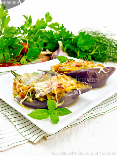 Image of Eggplant stuffed brisket and vegetables in plate on white board