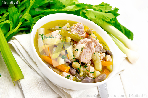 Image of Soup Eintopf in bowl on wooden board