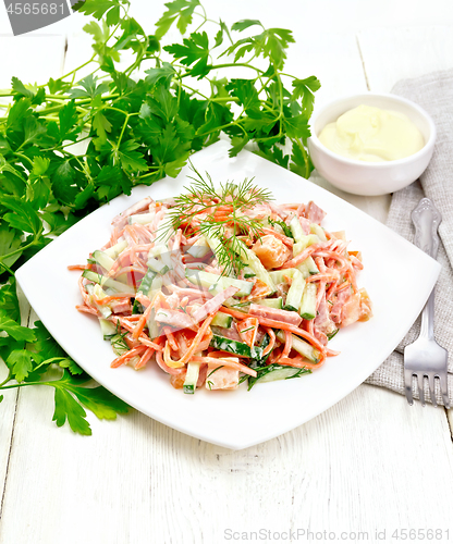 Image of Salad of sausage and spicy carrots with mayonnaise on wooden tab