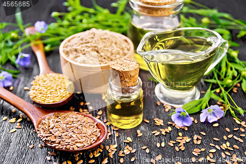 Image of Oil flaxseed with flour and seeds on dark board