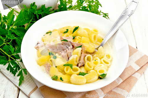 Image of Soup creamy of chicken and pasta in plate on light board
