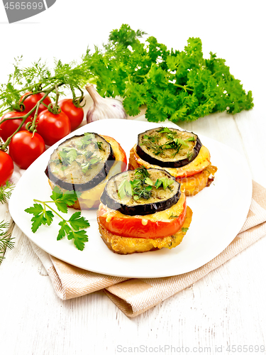 Image of Appetizer of aubergines and cheese on light board