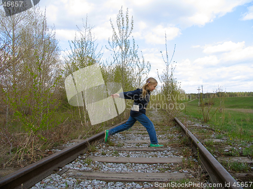 Image of Girl  running over railway