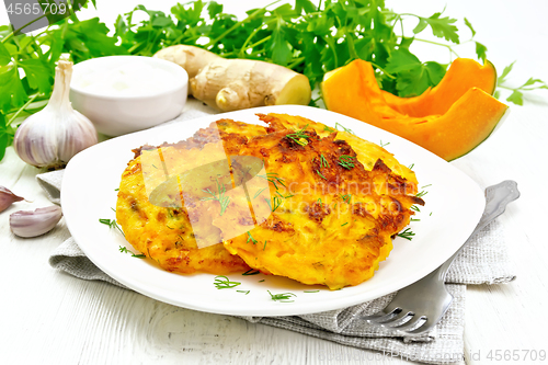 Image of Pancakes of pumpkin in plate on white board