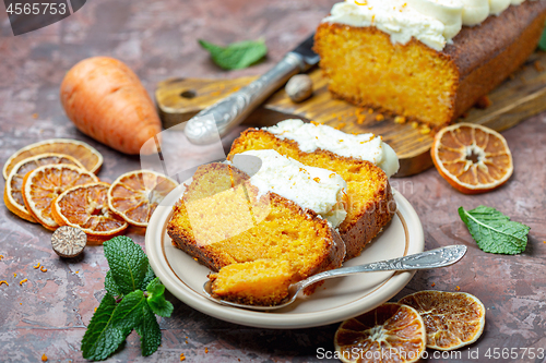 Image of Slices of homemade carrot cake on a ceramic plate.