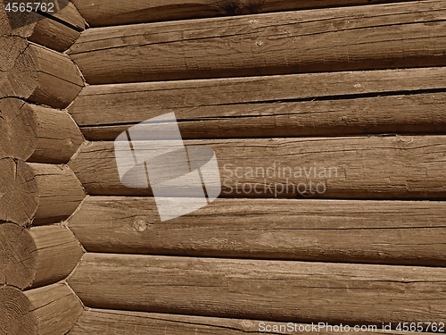 Image of Coner with big wooden logs outdoors, sepia