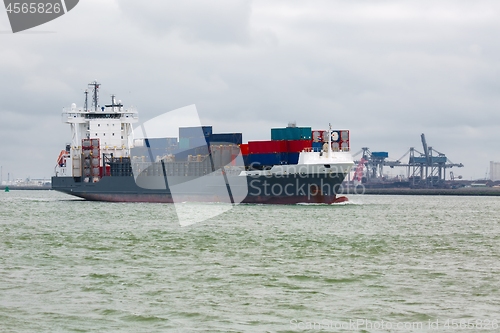 Image of Ship carrying containers through Rotterdam