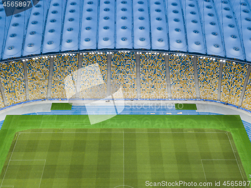 Image of Aerial view from the drone to the football stadium with the blue-yellow stands