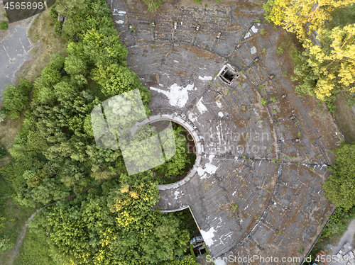 Image of Top view of the old destroyed roof and green trees on a summer day. Aerial view from the drone