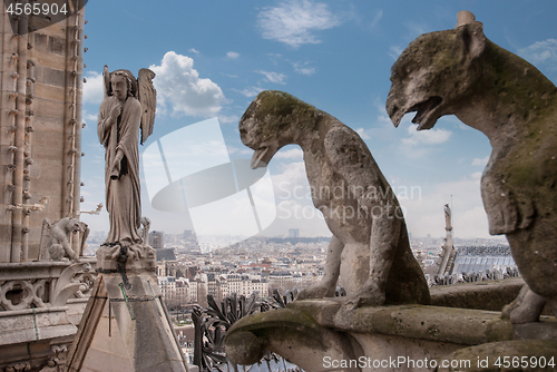 Image of Angel is playing an horn and gargoyles