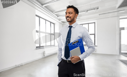 Image of indian businessman or realtor in empty office room