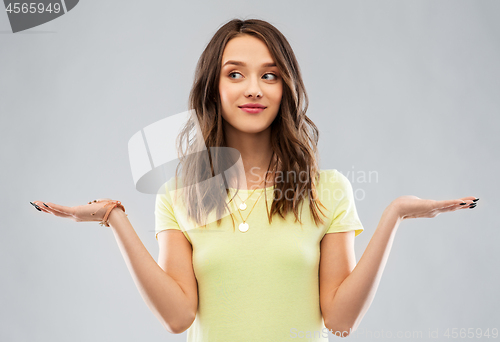 Image of happy teenage girl holding something imaginary