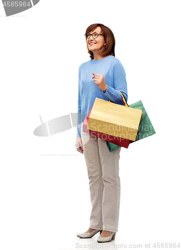 Image of senior woman with shopping bags isolated on white