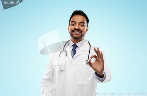 Image of smiling indian male doctor showing ok gesture