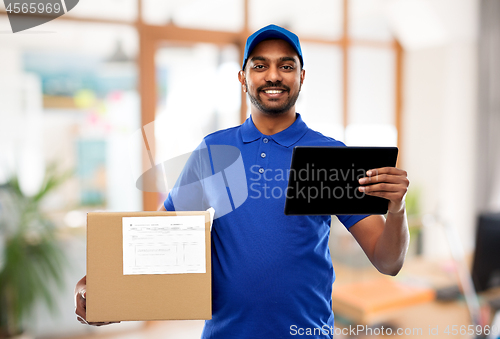 Image of indian delivery man with tablet pc and parcel box