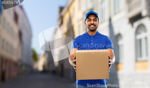 Image of happy indian delivery man with parcel box in city