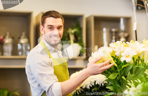 Image of florist or seller with white lilies at flower shop