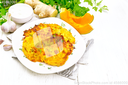 Image of Pancakes of pumpkin in plate on light board