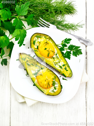 Image of Scrambled eggs in avocado on board top