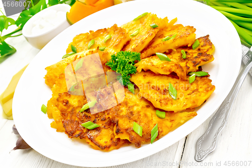 Image of Pancakes of pumpkin with cheese in plate on white board