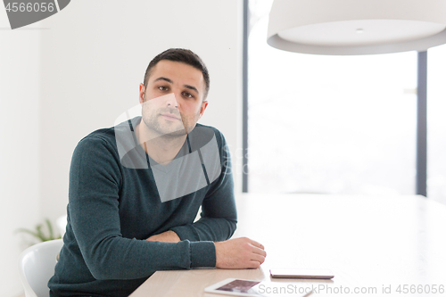 Image of Young casual businessman using smartphone