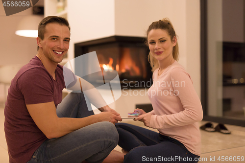 Image of Young Couple using digital tablet on cold winter night