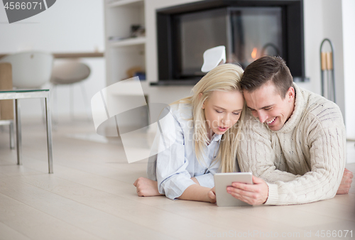 Image of Young Couple using digital tablet on cold winter day