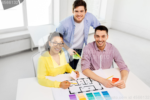 Image of designers with blueprint and color samples