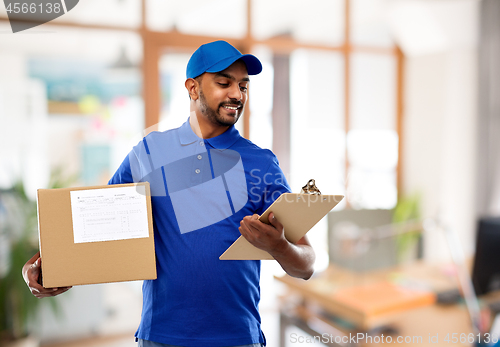 Image of delivery man with parcel and clipboard at office